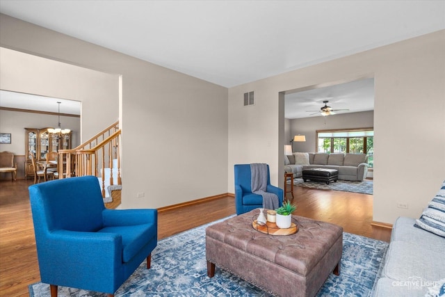 10660 Great Egret Dr, Orland Park, IL 60467 - living room featuring a chandelier, wood finished floors, and ceiling fan