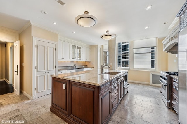 1550 N State Pkwy Unit 801, Chicago, IL 60610 - kitchen featuring stainless steel appliances, stone tile flooring, white cabinetry, glass insert cabinets, and ornamental molding