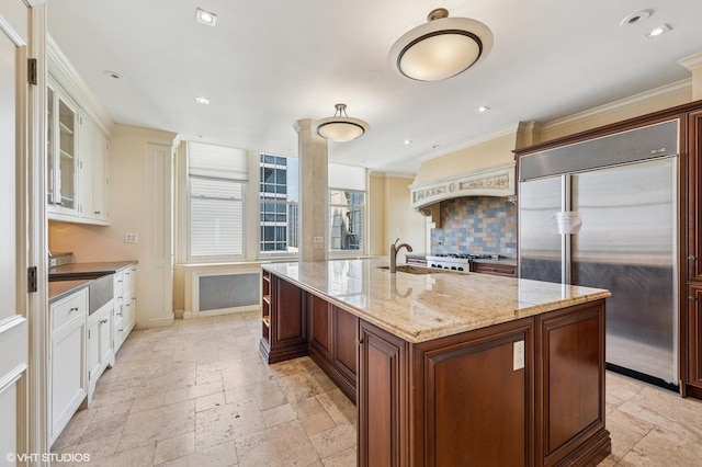 1550 N State Pkwy Unit 801, Chicago, IL 60610 - kitchen featuring stainless steel built in fridge, stone tile floors, backsplash, ornamental molding, and white cabinets