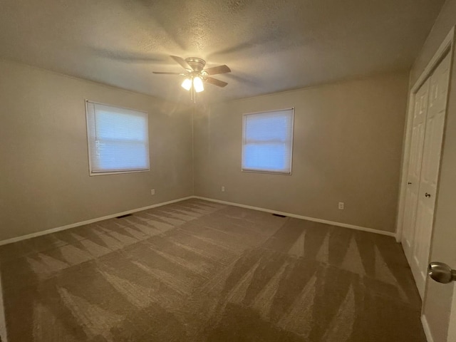 522 N 3rd Ave, Chenoa, IL 61726 - unfurnished bedroom featuring carpet, a closet, a textured ceiling, and ceiling fan