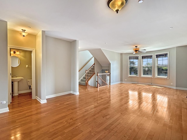 15 Busse Hwy, Park Ridge, IL 60068 - unfurnished living room with light wood finished floors, ceiling fan, and stairway