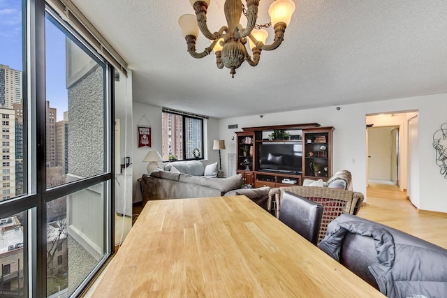 33 W Delaware Pl Unit 13A, Chicago, IL 60610 - dining room with a chandelier, wood finished floors, a textured ceiling, and a city view