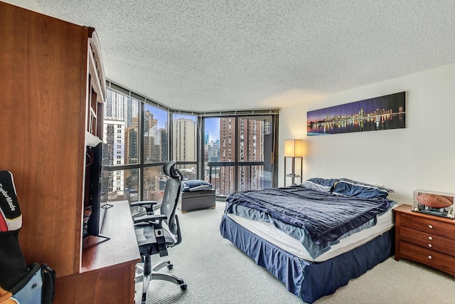 33 W Delaware Pl Unit 13A, Chicago, IL 60610 - bedroom with carpet, a textured ceiling, an office area, and floor to ceiling windows