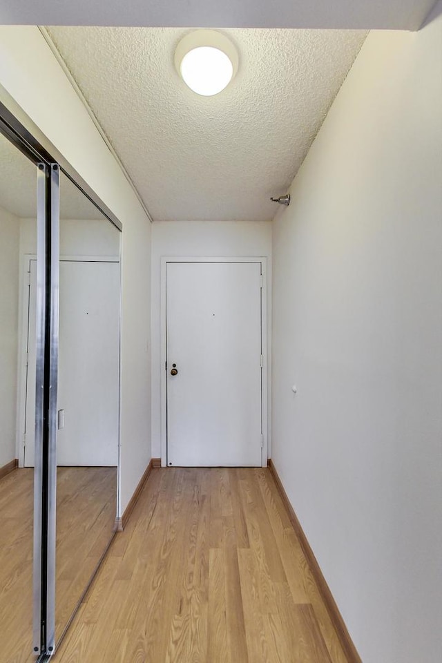 33 W Delaware Pl Unit 13A, Chicago, IL 60610 - hallway featuring light wood-type flooring and a textured ceiling