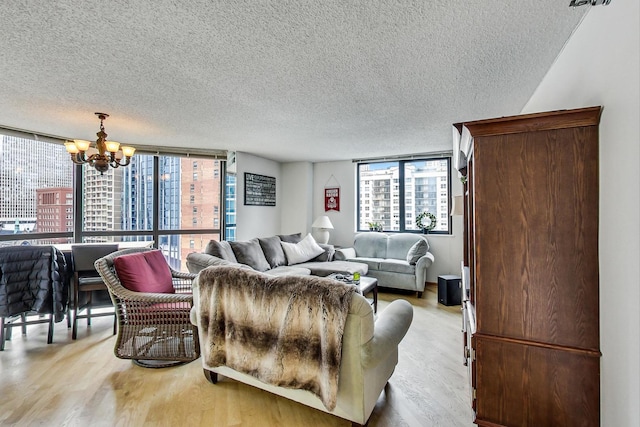 33 W Delaware Pl Unit 13A, Chicago, IL 60610 - living room with a chandelier, light wood finished floors, a textured ceiling, and plenty of natural light