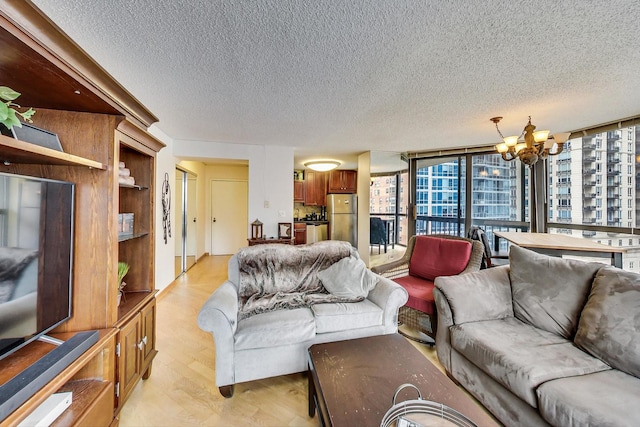 33 W Delaware Pl Unit 13A, Chicago, IL 60610 - living room featuring a textured ceiling, a chandelier, light wood-type flooring, and expansive windows