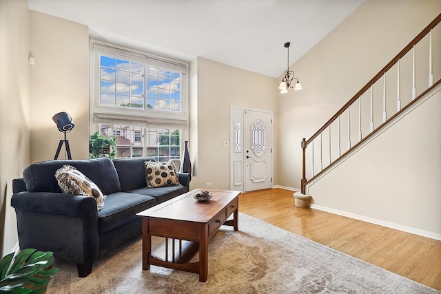 2330 Worthing Dr, Naperville, IL 60565 - living area with high vaulted ceiling, wood finished floors, stairs, and a chandelier