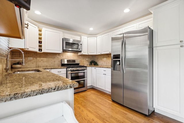 2330 Worthing Dr, Naperville, IL 60565 - kitchen featuring stainless steel appliances, white cabinets, light wood-style flooring, backsplash, and recessed lighting