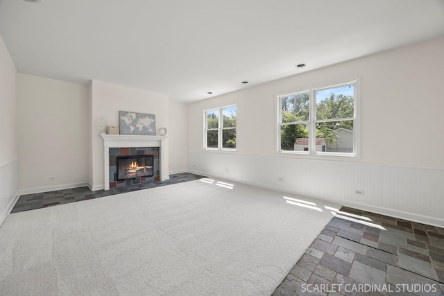 532 E Hawthorne Blvd, Wheaton, IL 60187 - unfurnished living room featuring a tile fireplace, wainscoting, and stone finish floors