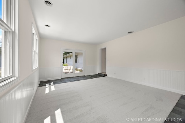 532 E Hawthorne Blvd, Wheaton, IL 60187 - spare room with wainscoting, healthy amount of natural light, and dark carpet