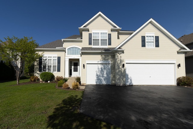 131 Glenbrook Cir, Gilberts, IL 60136 - traditional home with an attached garage, asphalt driveway, and a front lawn