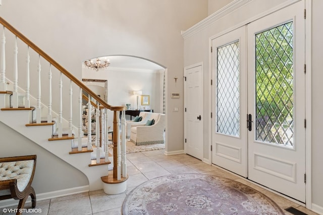 8S241 Dunham Dr, Naperville, IL 60540 - tiled entrance foyer with arched walkways, a towering ceiling, french doors, and stairway
