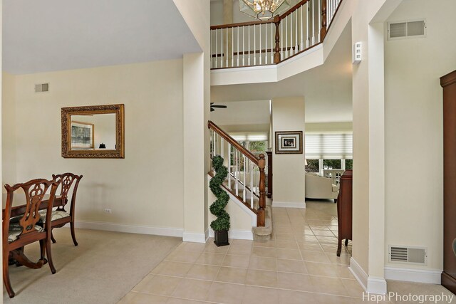 4 Shadow Creek Ct, Lake In The Hills, IL 60156 - entrance foyer featuring stairway, a towering ceiling, tile patterned floors, and a chandelier