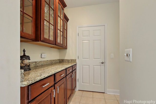 4 Shadow Creek Ct, Lake In The Hills, IL 60156 - kitchen with light tile patterned floors, light stone countertops, and glass insert cabinets