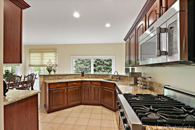 4 Shadow Creek Ct, Lake In The Hills, IL 60156 - kitchen with appliances with stainless steel finishes, light tile patterned flooring, light stone counters, recessed lighting, and a peninsula