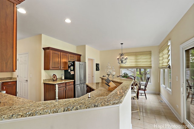 4 Shadow Creek Ct, Lake In The Hills, IL 60156 - kitchen with freestanding refrigerator, a chandelier, light tile patterned floors, light stone counters, and recessed lighting