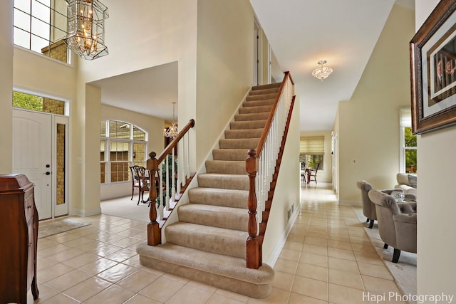 4 Shadow Creek Ct, Lake In The Hills, IL 60156 - foyer entrance featuring a chandelier, a high ceiling, light tile patterned floors, and stairs