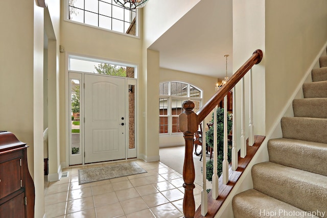 4 Shadow Creek Ct, Lake In The Hills, IL 60156 - entryway with a chandelier, a towering ceiling, stairs, and light tile patterned floors