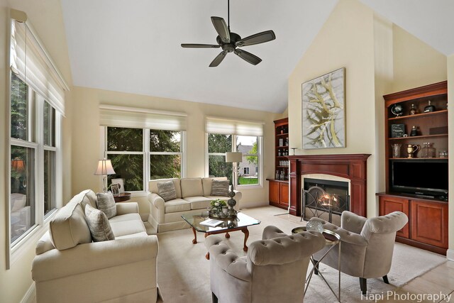 4 Shadow Creek Ct, Lake In The Hills, IL 60156 - living area featuring a fireplace with flush hearth, high vaulted ceiling, ceiling fan, and light wood-type flooring