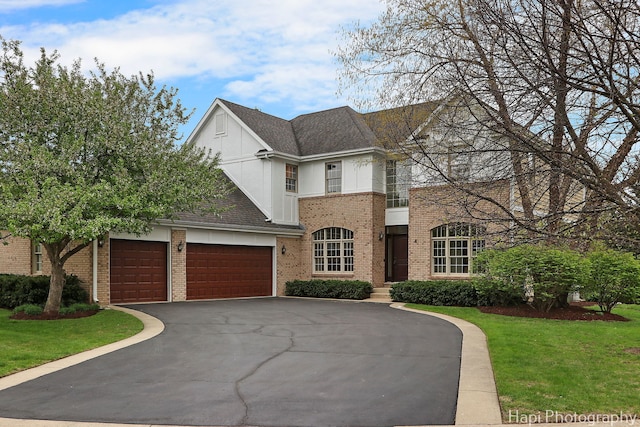 4 Shadow Creek Ct, Lake In The Hills, IL 60156 - view of front facade with asphalt driveway, a garage, a front yard, brick siding, and stucco siding