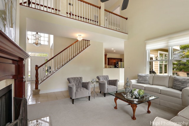 4 Shadow Creek Ct, Lake In The Hills, IL 60156 - carpeted living room featuring a towering ceiling, plenty of natural light, stairway, a chandelier, and tile patterned floors