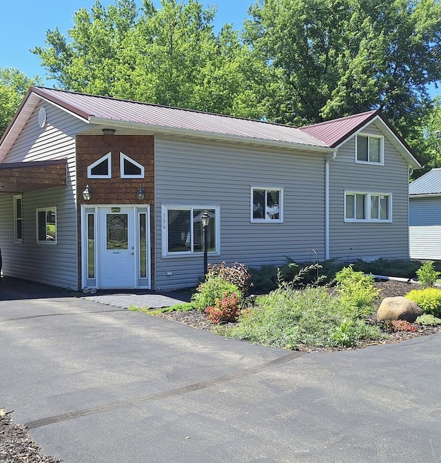 306 N Joy St, Tampico, IL 61283 - view of front of home with a carport, driveway, and a metal roof