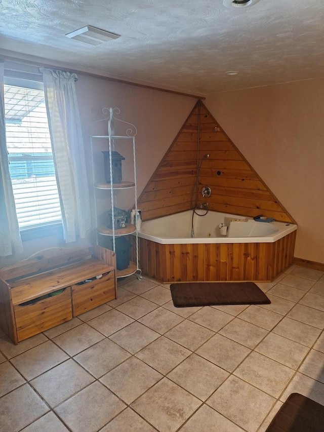 306 N Joy St, Tampico, IL 61283 - bathroom featuring a whirlpool tub, tile patterned floors, and a textured ceiling
