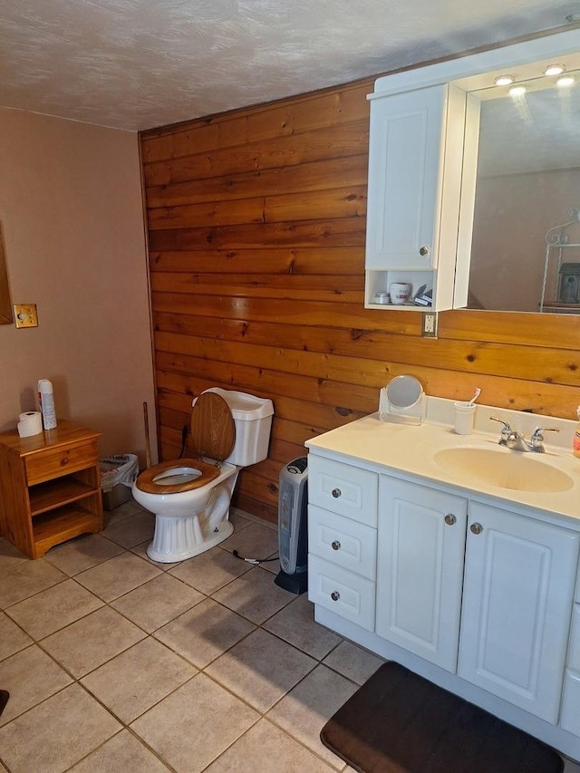 306 N Joy St, Tampico, IL 61283 - bathroom with tile patterned flooring, vanity, and wood walls