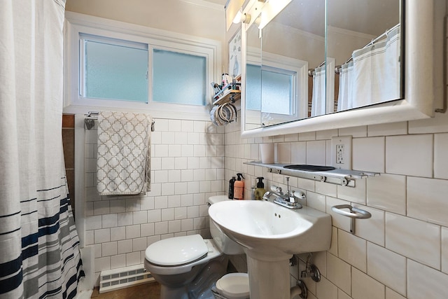 3414 Franklin St, Highland, IN 46322 - full bathroom featuring a baseboard radiator, ornamental molding, a shower with shower curtain, backsplash, and tile walls