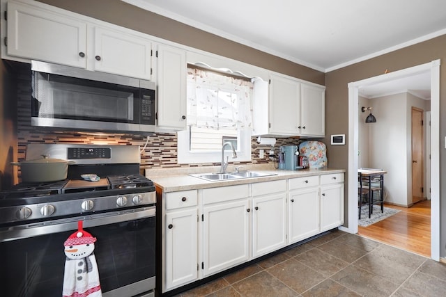 3414 Franklin St, Highland, IN 46322 - kitchen with appliances with stainless steel finishes, white cabinetry, crown molding, light countertops, and backsplash