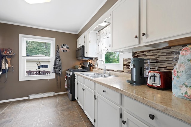 3414 Franklin St, Highland, IN 46322 - kitchen with appliances with stainless steel finishes, tasteful backsplash, white cabinetry, baseboard heating, and ornamental molding
