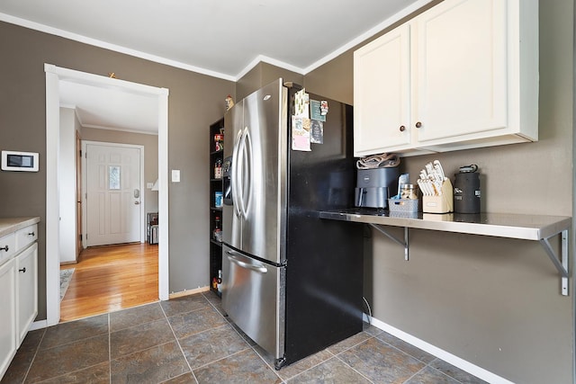 3414 Franklin St, Highland, IN 46322 - kitchen featuring stainless steel fridge, crown molding, white cabinets, and dark stone finish flooring