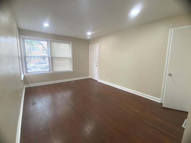 4907 Hull St, Skokie, IL 60077 - empty room with dark wood-style floors and recessed lighting