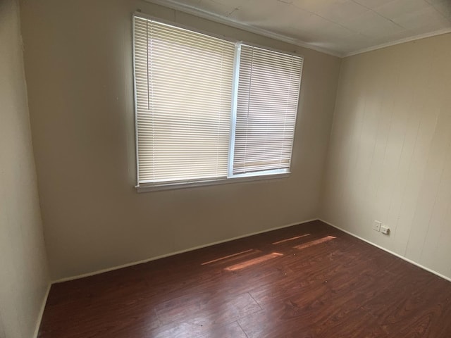 4907 Hull St, Skokie, IL 60077 - spare room with dark wood-style flooring and crown molding