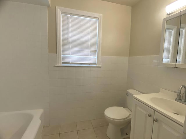 4907 Hull St, Skokie, IL 60077 - full bathroom with tile walls, tile patterned floors, a bathtub, vanity, and a wainscoted wall