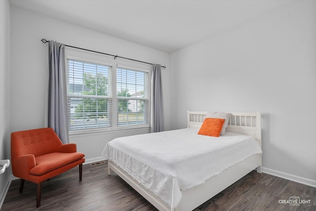 3385 Pecos Cir, Montgomery, IL 60538 - bedroom with baseboards and dark wood-type flooring