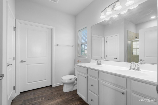 3385 Pecos Cir, Montgomery, IL 60538 - bathroom with a stall shower, double vanity, and wood finished floors