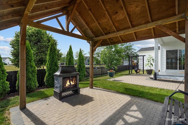 3385 Pecos Cir, Montgomery, IL 60538 - fenced backyard with a lit fireplace, a patio area, and a gazebo