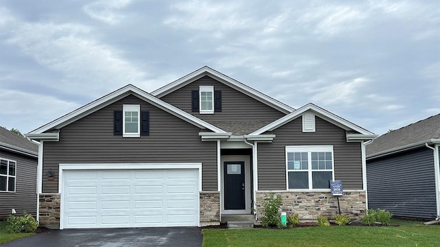 2522 Redwood Trl, Wonder Lake, IL 60097 - view of front of property with asphalt driveway, stone siding, a garage, and a front lawn