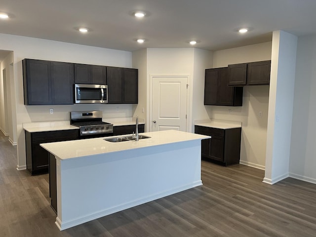 2522 Redwood Trl, Wonder Lake, IL 60097 - kitchen featuring stainless steel appliances, dark wood-style flooring, a center island with sink, light countertops, and recessed lighting