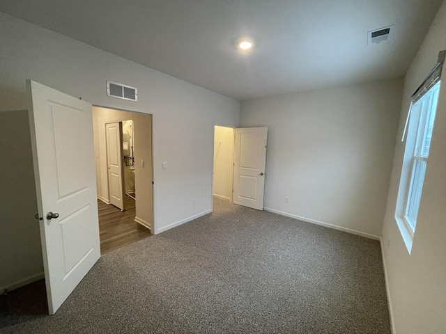 2522 Redwood Trl, Wonder Lake, IL 60097 - unfurnished bedroom featuring dark carpet and baseboards
