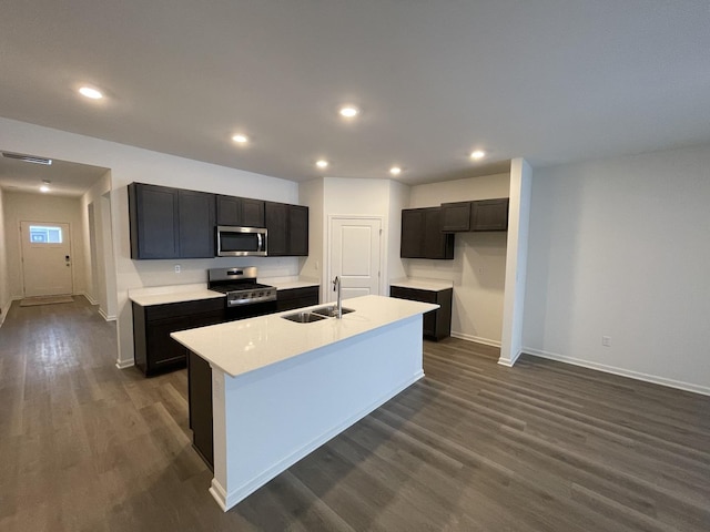 2522 Redwood Trl, Wonder Lake, IL 60097 - kitchen with stainless steel appliances, dark wood finished floors, recessed lighting, light countertops, and a center island with sink