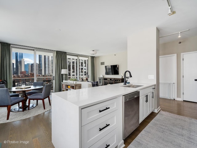 421 W Huron St Unit 1005, Chicago, IL 60654 - kitchen with dishwasher, track lighting, white cabinetry, light countertops, and dark wood finished floors