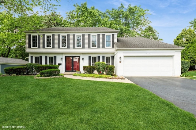 316 Ambleside Dr, Roselle, IL 60172 - colonial inspired home featuring asphalt driveway, a garage, a front lawn, and roof with shingles