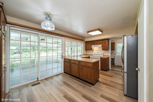 316 Ambleside Dr, Roselle, IL 60172 - kitchen with freestanding refrigerator, electric range, light countertops, a peninsula, and light wood-style floors