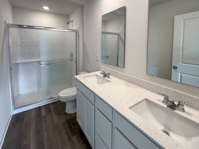 1052 58th Rd Unit 0021, Union Grove, WI 53182 - bathroom with a shower stall, wood finished floors, double vanity, and recessed lighting