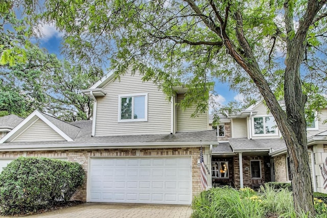 1604 Park Point, Ridge Point, Park Ridge, IL 60068 - view of front of home featuring decorative driveway, brick siding, an attached garage, and a shingled roof