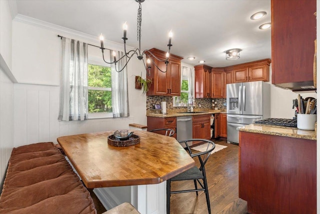 23463 N Meadow Ln, Barrington, IL 60010 - kitchen featuring appliances with stainless steel finishes, brown cabinetry, dark wood finished floors, crown molding, and tasteful backsplash