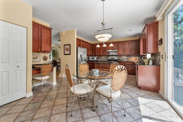 2636 Bainbridge Blvd, West Chicago, IL 60185 - dining area with baseboards and light stone finish floors
