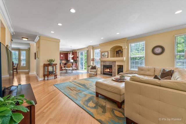 2636 Bainbridge Blvd, West Chicago, IL 60185 - living area with light wood-type flooring, ornamental molding, plenty of natural light, recessed lighting, and a tile fireplace